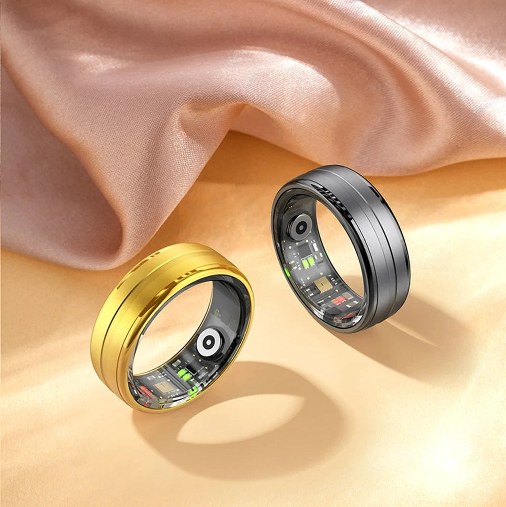 Two smart rings, one gold and one black, on a beige fabric background.